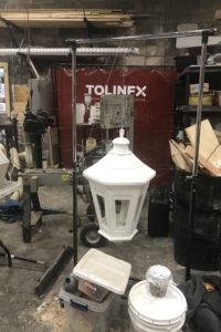 A white lantern hangs amid studio items in the Tolin FX shop.