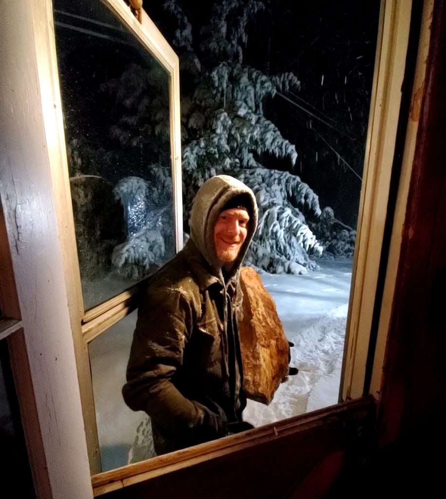 Steve Tolin carries firewood into his home on a particularly snowy day